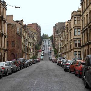 street lined with cars on a hill in Glasgow
